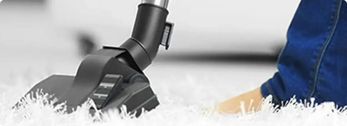 Close-up of a professional vacuuming a white carpet in Largo.